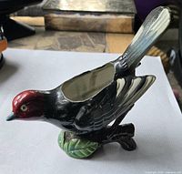 side view of ceramic bird planter showing colors and planting cavity