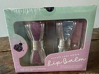 Front of sealed Purple Ladybug craft your own lip balm kit showing two glitter bow cases