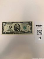 Obverse of $2 note showing portrait, serial number L27005438A