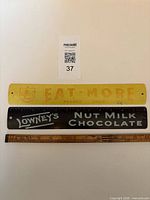 Front view of both metal advertising rulers with scale reference