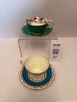 Two teacup and saucer sets displayed