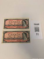 Fronts of both $2 Canadian banknotes with serial numbers
