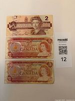 Fronts of all three $2 notes showing portraits, serial numbers
