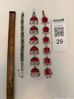 All three bracelets beside ruler showing length and MaxSold card