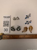 All four pairs of earrings with measurement reference