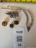 Group shot: rhinestone necklace, single-row rhinestone bracelet, bow brooch, micro-mosaic brooch, cameo earrings
