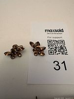 Front view of both earrings showing amber rhinestones cluster design
