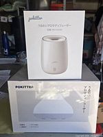 Two boxed Pokitter diffusers stacked, showing product images and sizes