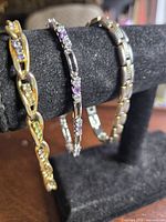 Three bracelets on display stand