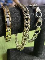 All three bracelets displayed on bracelet stand