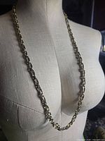 Full view of necklace draped on mannequin to show overall length and design
