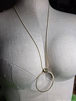 Necklace displayed on dress form showing overall length and pendant