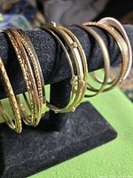 All bangles on display stand, showing textures and finishes