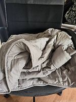 Grey weighted blanket draped on chair