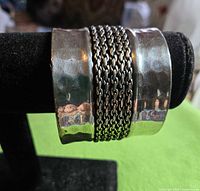 Front view of cuff showing hammered panels and chain mesh center