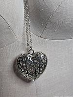 heart pendant on mannequin showing design and chain