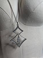 Necklace displayed on mannequin showing pendant drop length