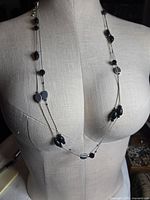 Full view of necklace draped on mannequin displaying bead placement and length