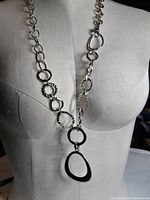 Full view of necklace on mannequin showing link pattern and teardrop pendant