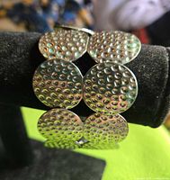 Front view of silver-tone bracelet showing linked hammered discs