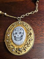 Close-up of locket front showing skull image and rhinestone setting
