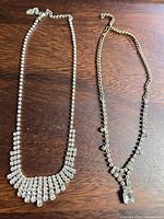 Both necklaces laid out side by side showing overall design