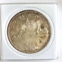 Full view of 1965 Canadian silver dollar in 2x2 holder