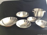 Group view of five mixing bowls and one colander