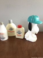 Group shot of Snoopy bottle and three Old Spice bottles