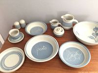 All 13 stoneware pieces arranged on table