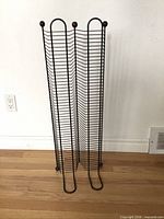 Front view of black metal CD storage tower