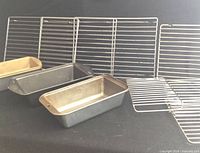 three loaf pans front, seven cooling racks background