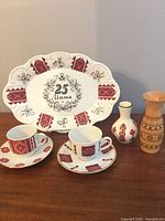 Group shot of platter, cups, saucers, vases