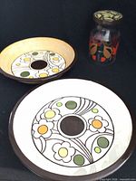 Two ceramic pie plates and glass jar positioned together