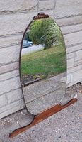 Front view of oval mirror showing full frame and base