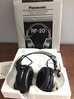 Headphones in foam insert with box and paperwork visible