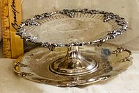 Pedestal compote resting on matching plate showing overall style and ruler for scale