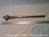 Full view of breaker bar alongside ruler for scale