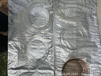 five round glass baking dishes on tarp