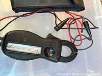 Front view of Amprobe clamp meter with test leads attached