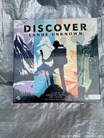 Front of sealed Discover: Lands Unknown board game box