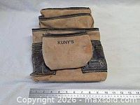 Front view of Kuny's leather tool pouch with ruler for scale