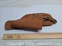 Full view of leather drill holster beside ruler showing length