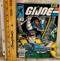 Front cover of G.I. Joe comic beside ruler for scale