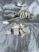 Massager body and six attachment heads displayed