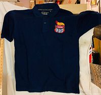 Front view of navy polo with Hot Wheels Highway 35 patch