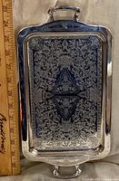 Front view of tray showing engraved design next to ruler