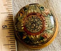 Top view showing lacquered design and ruler for scale