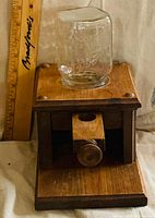 front view showing wooden body, drawer, glass hopper