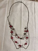 Full view of entire necklace laid flat showing length, clasp and strand arrangement